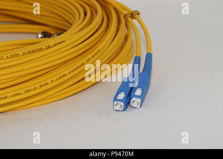 Open Fiber optics SC connectors single mode patch cord , isolated on white background Stock Photo