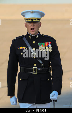 Major Russell Fluker, parade adjutant, Marine Barracks Washington D.C., calls a command during a Tuesday Sunset Parade at the Lincoln Memorial, Washington D.C., July 10, 2018. The guest of honor for the parade was the former Vice President of the U.S., Joe Biden, and the hosting official was the Staff Judge Advocate to the Commandant of the Marine Corps, Maj. Gen. John R. Ewers Jr. (Official Marine Corps photo by Cpl. Damon Mclean/Released)