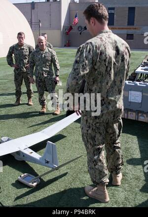 Fleet Master Chief Russell Smith serves as a senior enlisted leader in the United States Navy and temporarily assumed the duties of Master Chief Petty Officer of the Navy in July 2018. He views unmanned aerial systems on display at Special Reconnaissance Team One at Naval Amphibious Base San Diego on July 12, 2018. The archival image records Naval Special Warfare capability demonstrations during a West Coast visit. Stock Photo