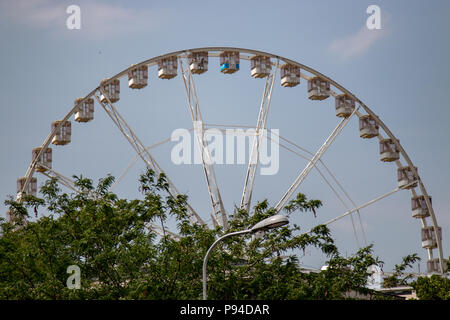 A partial view of the Budapest Eye through the trees on a sunny summer day Stock Photo