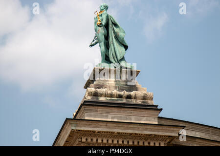 The statue of Knowledge and Glory on top of the right colonnade of the Millennium Monument in Heroes Square, Budapest. Stock Photo