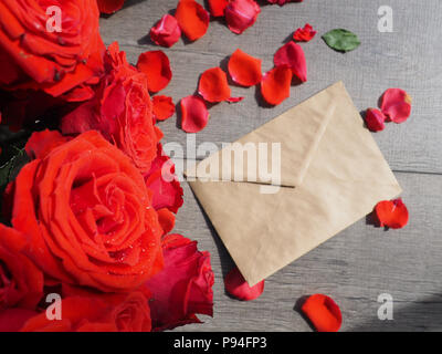 Envelop with white card and rose background. Top view., Envelope with flowers summer, spring Stock Photo