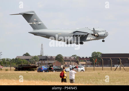 British aircraft enthusiasts observe as a USAF C-17 Globemaster lands at RAF Mildenhall carrying a USMC helicopter during the US Presidents visit. Stock Photo