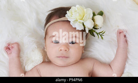 Serious cute little baby girl portrait on soft background Stock Photo