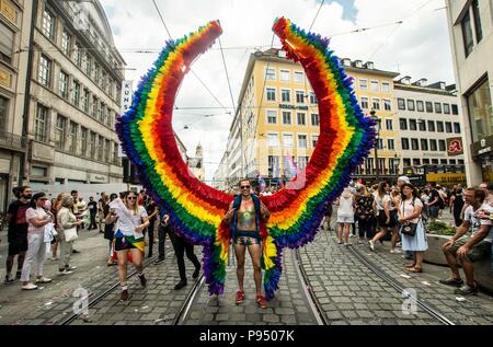 Munich, Bavaria, Germany. 14th July, 2018. A participant of the Christopher Street Day parade in Munich, Germany shows off his large construction of pride wings. Under the banner diverse-colorful is the new white blue and capping off nine days of Pride Week. Credit: Sachelle Babbar/ZUMA Wire/Alamy Live News Stock Photo