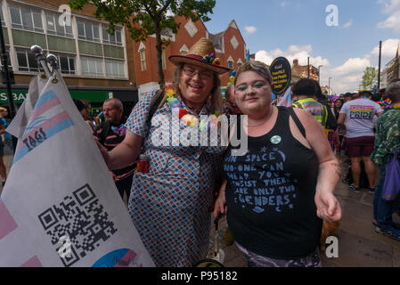 London, UK. 14th July 2018. People waiting for the start of the Croydon Pride procession pose for a photograph. Several hundred people paraded through the centre of Croydon on their way to the third Croydon Pridefest, sponsored by Croydon Council, in Wandle Park. Many were in colourful dress and there were banners, flags, placards, posters and unicorns. The free festival aims to promote LGBT+ equality and diversity in Croydon, and is London's second largest Pride festival. Following the disruption by anti-Trans activists at London Pride, the parade gave the Trans People Across London (TRANSPAL Stock Photo