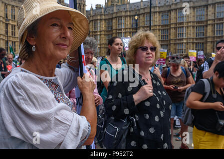 London, UK. 14th July 2018. A woman holds a Jewish Voice for Labour banner at the protest in Old Palace Yard to peacefully oppose the protest by right-wing groups supporting the campaign to free jailed former EDL leader Tommy Robinson and support President Trump. .After some opening speeches the organisers Credit: Peter Marshall/Alamy Live News Stock Photo