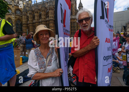 London, UK. 14th July 2018. Jewish Voice for Labour activists hold banners in Old Palace Yard to peacefully oppose the protest by right-wing groups supporting the campaign to free jailed former EDL leader Tommy Robinson and support President Trump. .After some opening speeches the organisers tried to march Credit: Peter Marshall/Alamy Live News Stock Photo