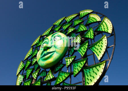 Round Circular colourful tableau, geometric designs of sunbursts, starbursts in Blackpool, Lancashire, UK Weather. 15/07/2018. Sunny start to the day at the coast as Sun burst installations, part of the Illuminations tableau spectacular appear on the section of the promenade as local residents, cyclists and tourists enjoy the early morning sun. Blackpool Illuminations is an annual lights festival, founded in 1879 and held each autumn in the British seaside resort of Blackpool on the Fylde Coast  Credit: MediaWorldImages/AlamyLiveNews Stock Photo