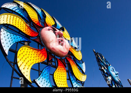 Round Circular colourful tableau, geometric designs of sunbursts, starbursts in Blackpool, Lancashire, UK Weather. 15/07/2018. Sunny start to the day at the coast as Sun burst installations, part of the Illuminations tableau spectacular appear on the section of the promenade as local residents, cyclists and tourists enjoy the early morning sun. Blackpool Illuminations is an annual lights festival, founded in 1879 and held each autumn in the British seaside resort of Blackpool on the Fylde Coast  Credit: MediaWorldImages/AlamyLiveNews Stock Photo