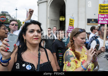 London, UK. 14th July, 2018. Supporters of Tommy Robinson, the former leader of the English Defence League who was imprisoned in May following a contempt of court, observe anti-fascists marching through London to oppose the 'Free Tommy' and 'Welcome Trump' marches. Credit: Mark Kerrison/Alamy Live News Stock Photo