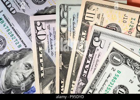 Dollar bills of different value on the table Stock Photo