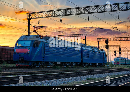railroad infrastructure during beautiful sunset and colorful sky, trains and wagons, transportation and industrial concept Stock Photo