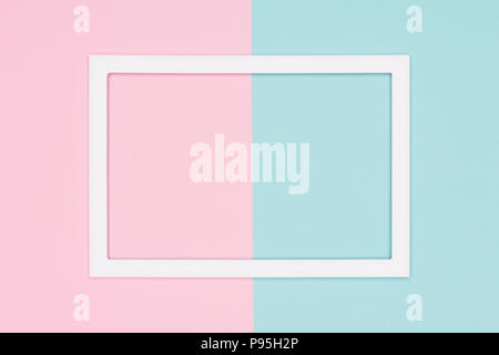 Abstract geometrical pastel blue and pink colored paper flat lay background. Minimalism template with empty picture frame mock up. Stock Photo