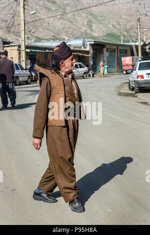 Howraman, Kurdistan Province, Iran - April 5, 2018: Kurdish man in traditional clothing on the street of Howraman village or Uraman Takht in Zagros Mo Stock Photo