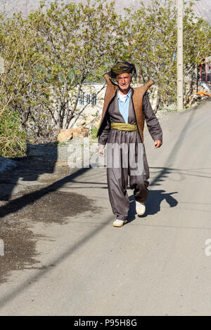 Howraman, Kurdistan Province, Iran - April 5, 2018: Kurdish man in traditional clothing on the street of Howraman village or Uraman Takht in Zagros Mo Stock Photo