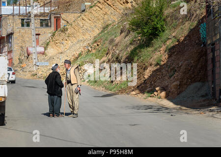 Howraman, Kurdistan Province, Iran - April 5, 2018: Kurdish men in traditional clothing on the street of Howraman village or Uraman Takht in Zagros Mo Stock Photo