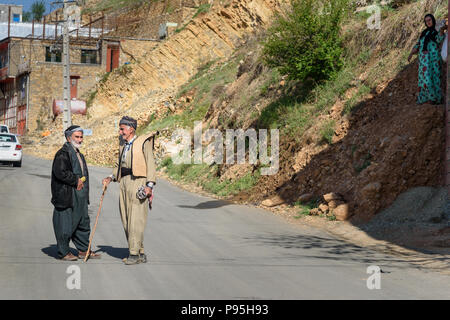 Howraman, Kurdistan Province, Iran - April 5, 2018: Kurdish men in traditional clothing on the street of Howraman village or Uraman Takht in Zagros Mo Stock Photo