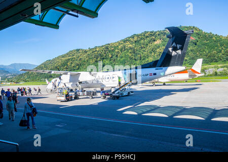 Austrian Airlines OE-LGP Bombardier Dash 8-Q402 at Lugano Airport Switzerland from Zurich Propeller plane travel concept tourists Stock Photo