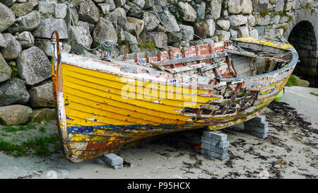 Remains of an Old wooden boat, vintage rowboat, broken chipped wood, Galway Ireland old concept, battered abandoned ruins remains marine fishing Stock Photo