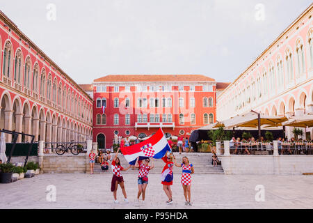 A group of Croatian women hold the Croatian flag in front of the Republic Square, Split to celebrate the World Cup Stock Photo