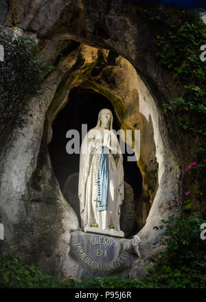 Statue of the Holy Virgin Mary in the grotto of Lourdes Stock Photo