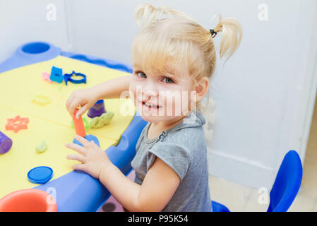 Plasticine modeling clay. Child dough play in school mold from plasticine  in kindergarten .Kids knead modeling clay with hands in preschool Stock  Photo - Alamy