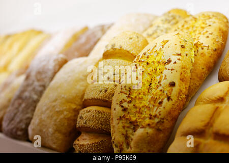 Different types of bread on a bakery display. Selective focus. Stock Photo