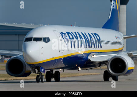 A Ryanair Boeing 737-8AS taxis along the runway at Manchester Airport whilst preparing to take off. Stock Photo