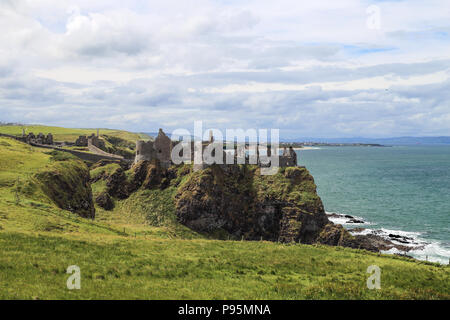 Dunluce Castle is a now-ruined medieval castle in Northern Ireland. It is located on the edge of a basalt outcropping in County Antrim. Stock Photo