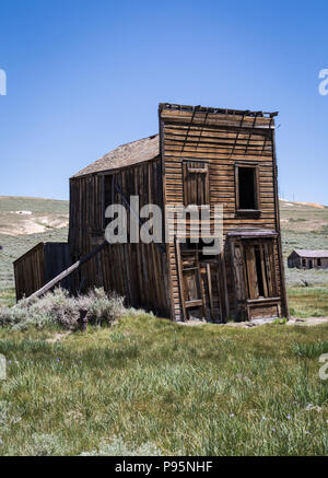 An old hotels leans to the side in the abandoned Old West town of Bodie, California, which is now a preserved State Park. Stock Photo