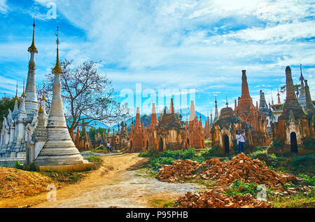 INLE LAKE, MYANMAR - FEBRUARY 18, 2018: The Nyaung Ohak Buddhist complex with ancient stupas during the reconstruction, Inthein village, on February 1 Stock Photo