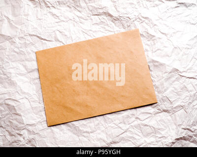 envelope of Kraft paper lies on crumpled paper Stock Photo