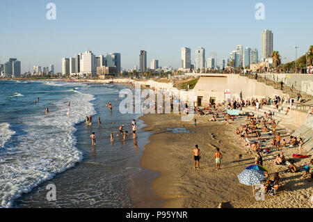 Beautiful Jaffa and Alma Beaches packed with people with Tel Aviv skyline in the background Stock Photo