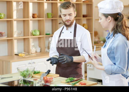 Two Young Chefs in Restaurant Kitchen Stock Photo