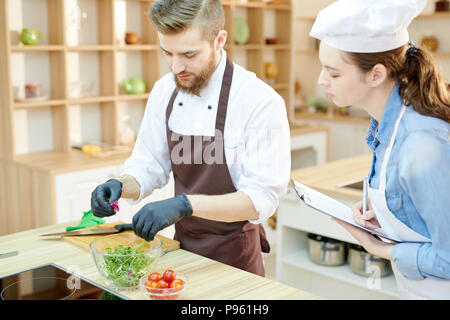 Young Chef Working in Restaurant Kitchen Stock Photo