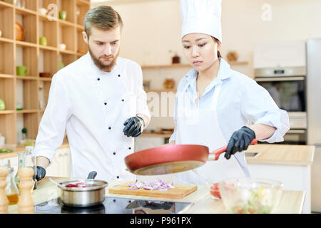 Two Professional Chefs at Work in Kitchen Stock Photo