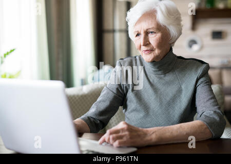 Senior woman using laptop Stock Photo