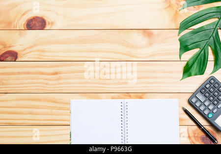 Top view of pen with calculator and notebook on wooden table and copy space for insert text. Stock Photo