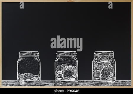 Investment or saving concept. Black chalkboard with tree glass jar and stacked coins in three step with chalk brush style design. Copy space. Stock Photo