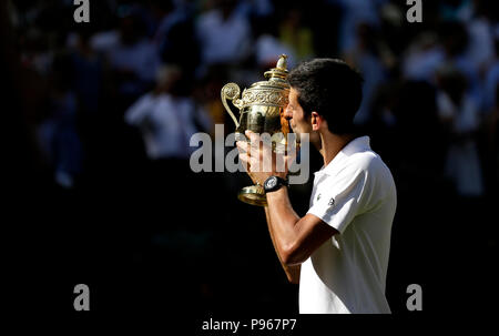 Novak Djokovic with the trophy after winning the Gentlemen's Singles Final against Kevin Anderson on day thirteen of the Wimbledon Championships at the All England Lawn Tennis and Croquet Club, Wimbledon. Stock Photo