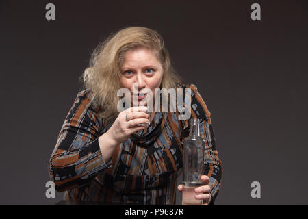 Drunk girl holding bottle of vodka Stock Photo - Alamy