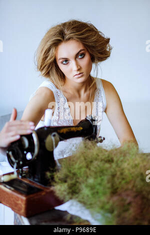 Pretty Woman. In the style of Coco Chanel sitting on a sewing machine Stock Photo