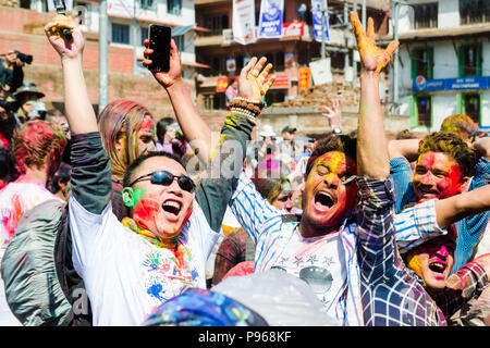 People celebrating during the traditional Hindu Holi festival of colors celebrations in Kathmandu Basantapur Durbar Square, Nepal Stock Photo