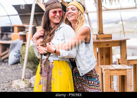 couple of crazy females friends have fun and enjoy lifestyle wearing hippy old retro style clothes and accessories. fashion and friendship for young c Stock Photo