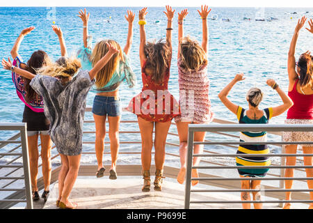 group of women enjoying and celebrate summer vacation all together saying hallo to the ocean and the nature. young people leisure activity, all hands  Stock Photo