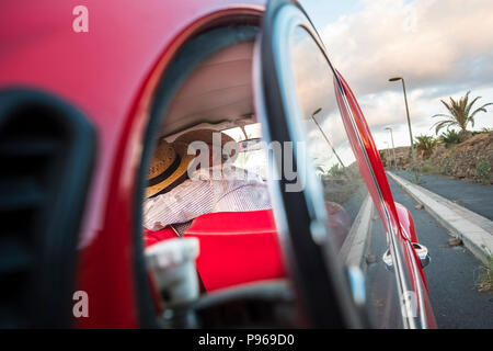 love kiss captured from a car glass. two senior man and woman kissing with love and celebrate a life together forever. travel and vacation. people enj Stock Photo