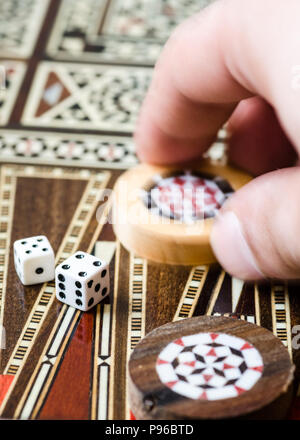 Checkers and dices on backgammon board game Stock Photo