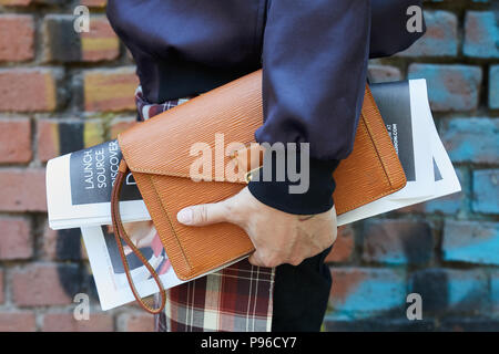 Man with Louis Vuitton bag in hand and Hermes belt on June 18, 2018 in  Milan, Italy Stock Photo
