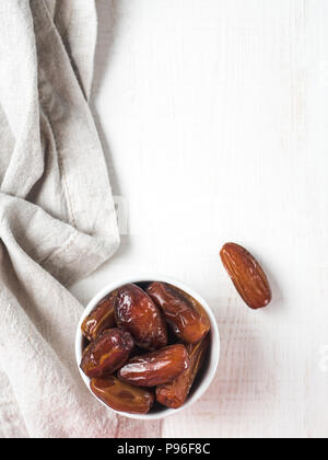 Plate of dried dates on table Stock Photo